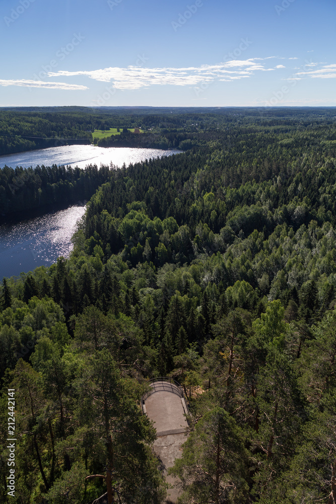 Scenic view of a lake, forests and observation point from Aulanko lookout tower in Hämeenlinna, Finland, in the summer.