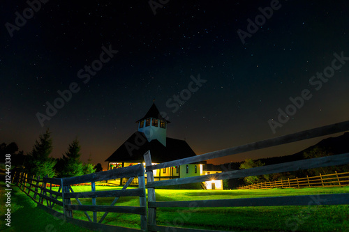 Night sky with shiny stars and church in the garden photo