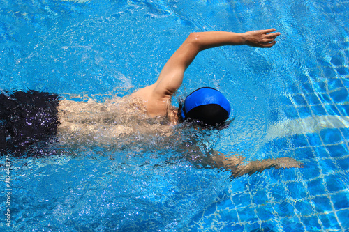 Portrait of athletic young man freestyle swimming in the pool, Healthy lifestyle concept