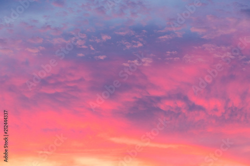 Details of clouds at sunset with dark orange, pink, and blueish purple tones © bacothelock