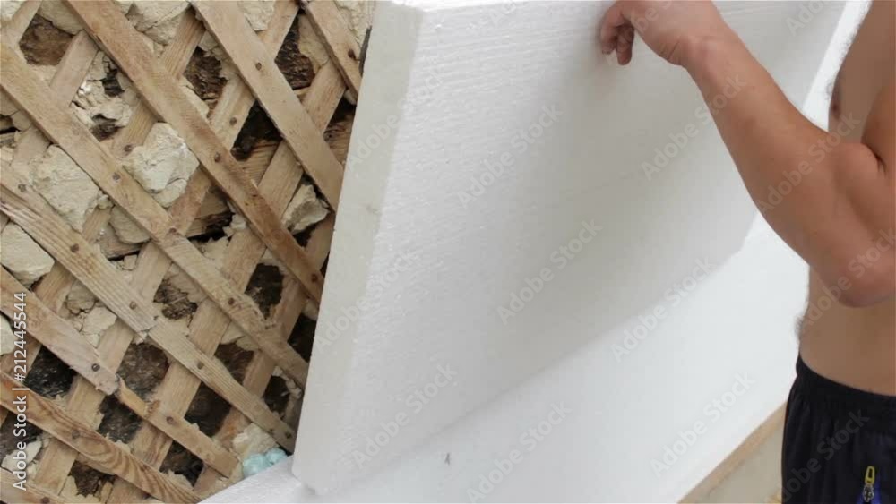 Gluing Styrofoam to the house,Man glue Styrofoam sheet to the wall of