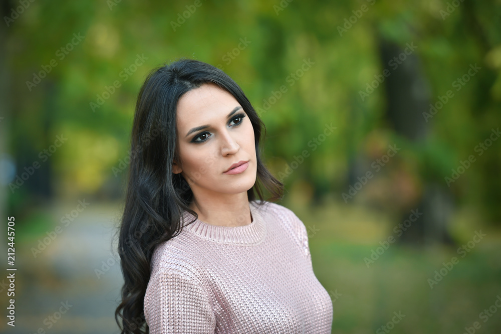 young fashion woman portrait in a park in autumn young fashion woman portrait in a park in autumn