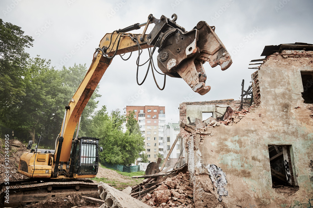 Fototapeta premium excavator crasher machine at demolition on construction site