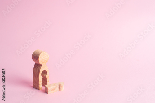 Fotografija A wooden figure of a woman with a void from which a child fell