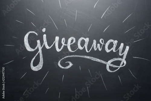 Inscription Giveaway written on the board with gifts