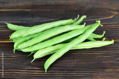 Green beans on wooden background