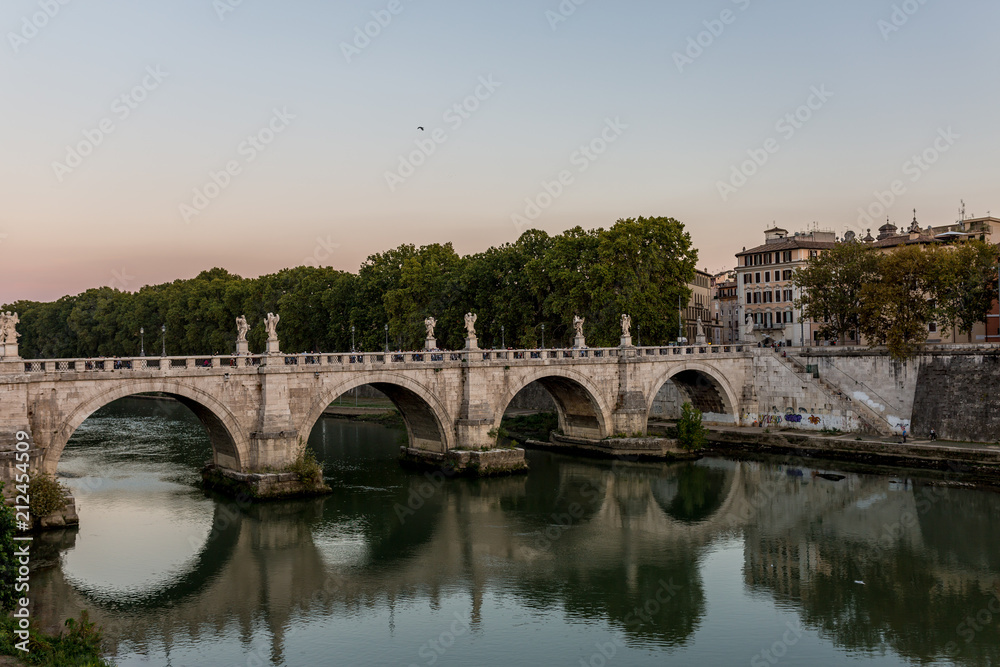 Ancient bridge in Rome reflecting in the mirror at sunset