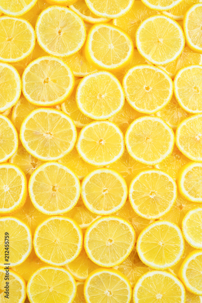 A slices of fresh juicy yellow lemons.  Texture background, pattern.