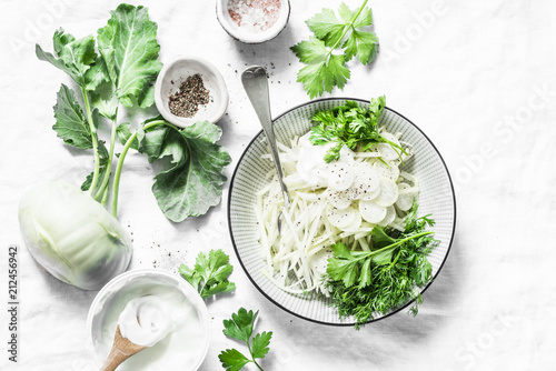 Fotografie Kohlrabi and daikon slaw salad on a light background, top view