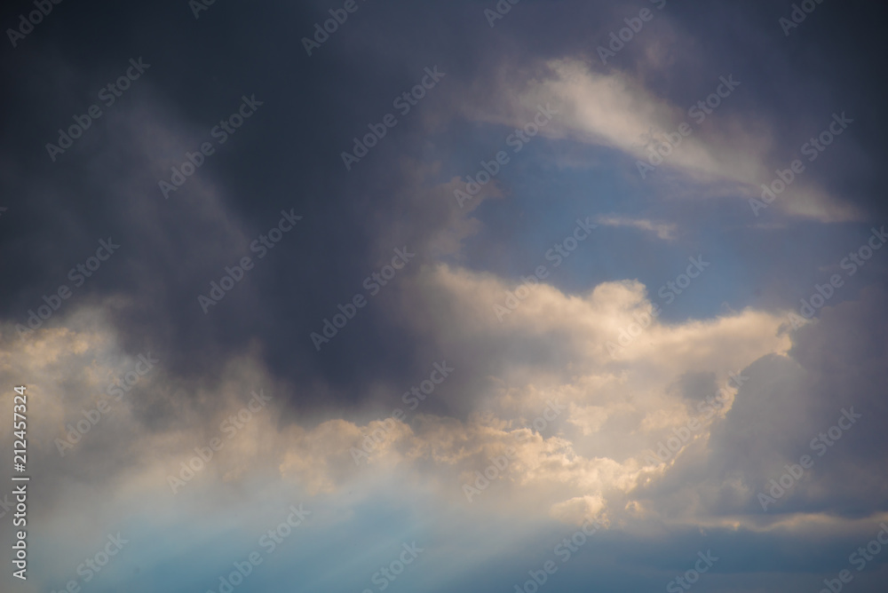 Rays of light shine through layers of storm clouds Rays of light shine through layers of storm clouds