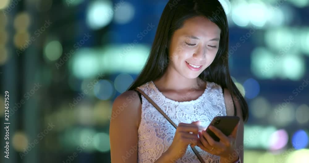 Asian woman use of mobile phone at night Asian woman use of mobile phone at night