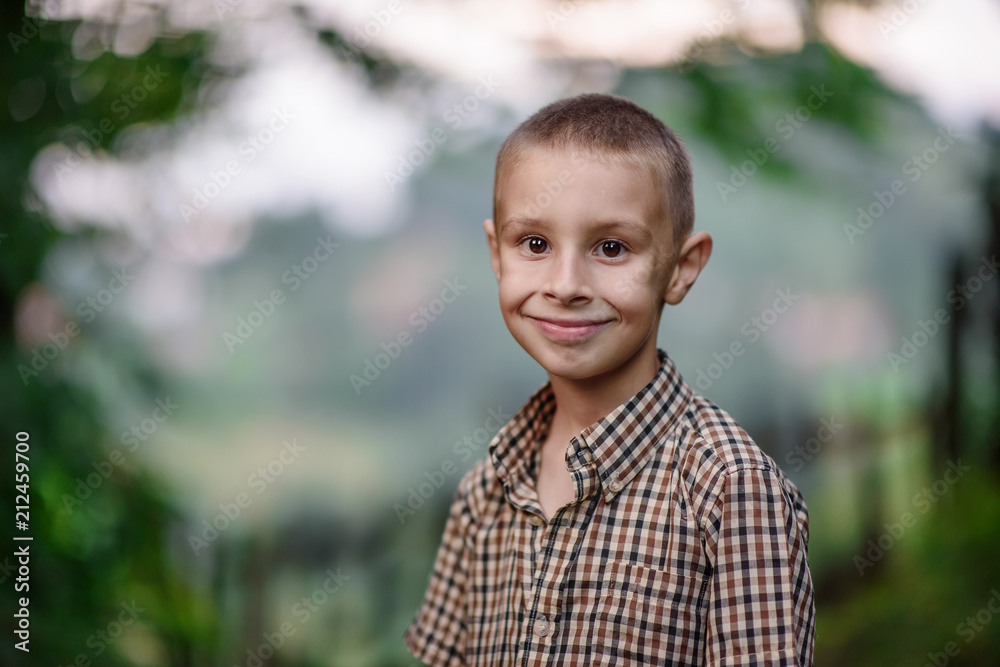 photo with a portrait of a boy outdoors photo with a portrait of a boy outdoors