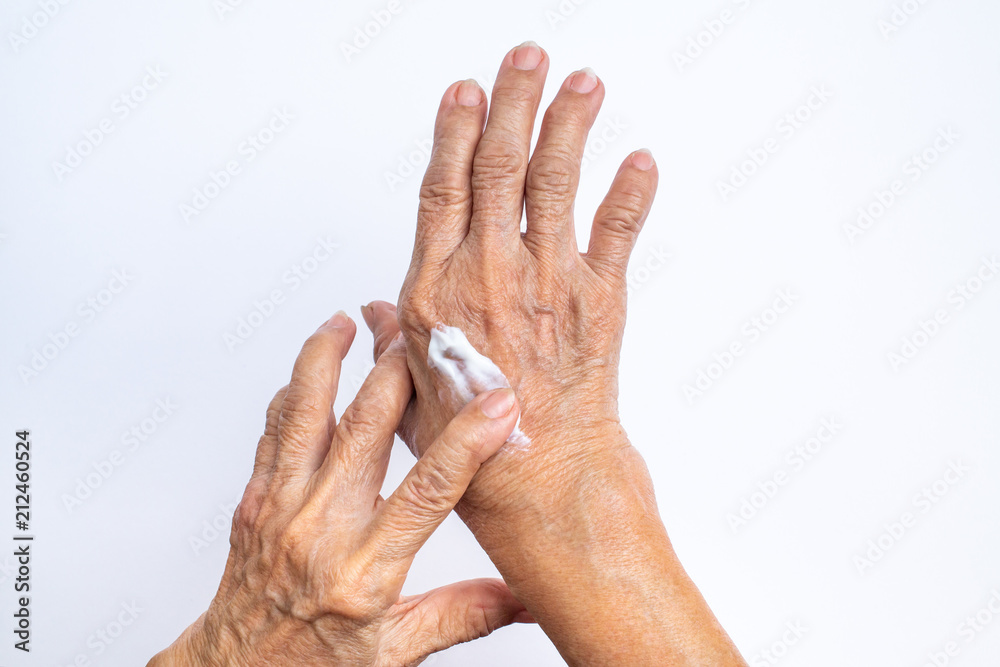 Senior Woman applying moisturizing cream on her hands isolated on white background, Beauty concept skin Senior Woman applying moisturizing cream on her hands isolated on white background, Beauty concept skin
