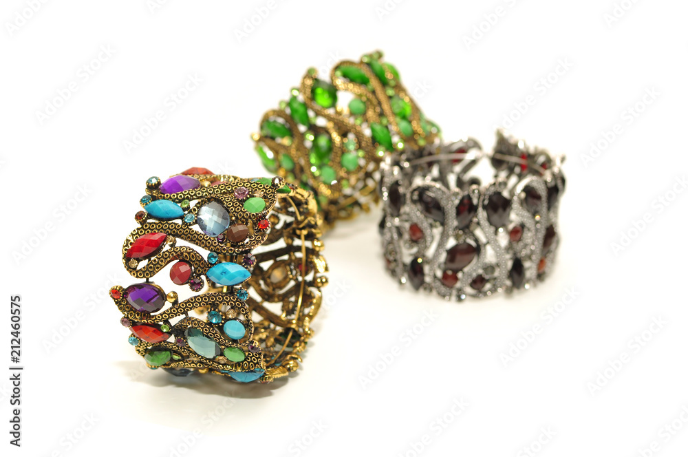 Big wide antic gold silver bangle with colorful gem and rhinestone isolated on white background Big wide antic gold silver bangle with colorful gem and rhinestone isolated on white background
