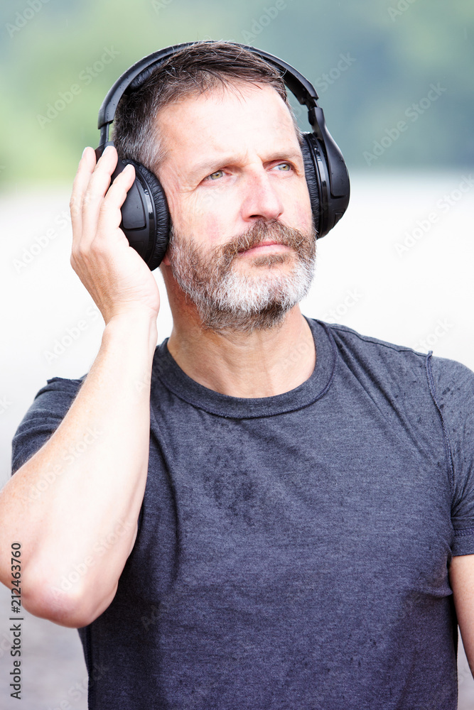 handsome bearded man with headphones outdoors handsome bearded man with headphones outdoors