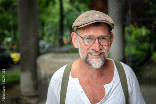 portrait of handsome smiling bearded man in his 50s