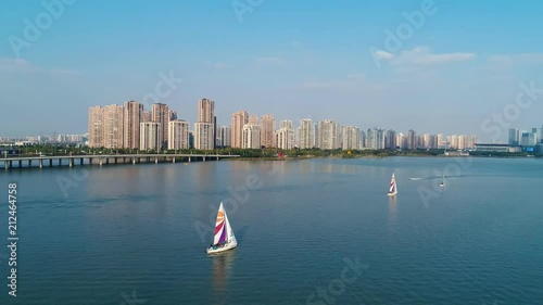 Aerial view of sailing boat in blue water lake, top view photo