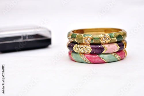Stack of gold bangle with vivid color and jewelry box isolated on white background
