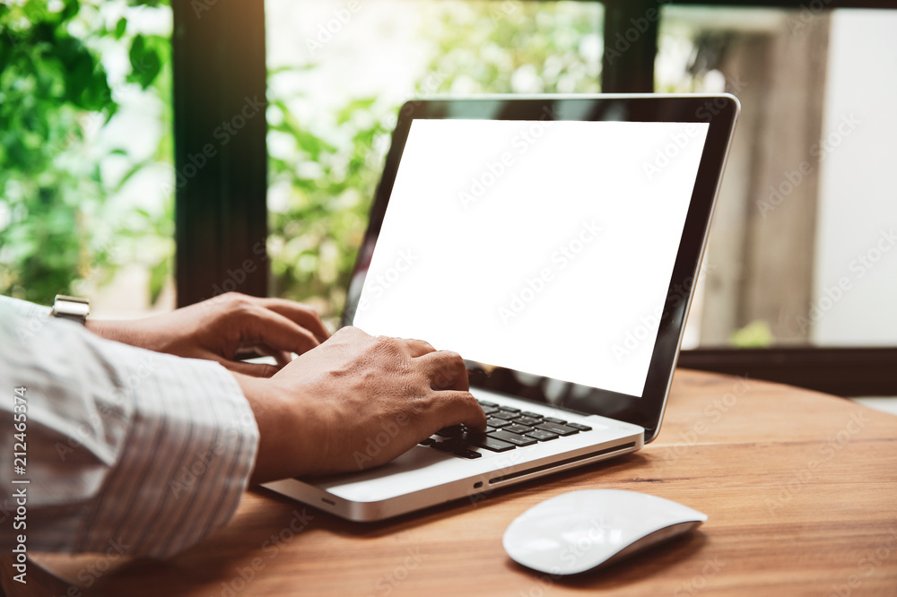 Business man hands using laptop with blank screen on desk in cafe. instagram style filter photo vintage tone Business man hands using laptop with blank screen on desk in cafe. instagram style filter photo vintage tone