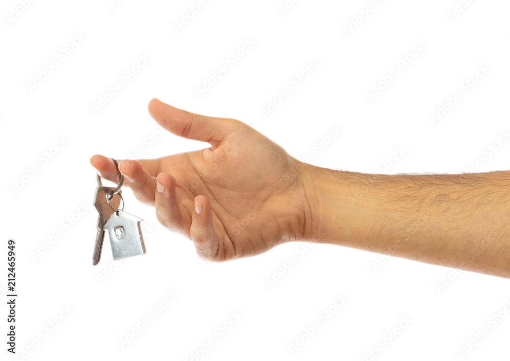 Hand holding a house key isolated on white background, clipping path Hand holding a house key isolated on white background, clipping path