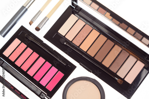 Obraz na płótnie Collection of two cosmetics palettes for eye and lip makeup isolated. Vivid colorful tints, hot colors for face make-up. Lipsticks and eyeshadows kit. Mascara, brushes and powder. Top view. w salonie