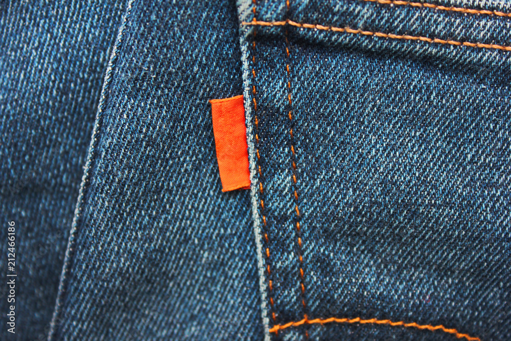 Denim Jeans Empty Red Label Close Up. Casual Vintage Style Jean Clothing Back Side Tag View. Dark Blue Denim Jeans Material with Empty Brand Label Top View. Stock Adobe Stock