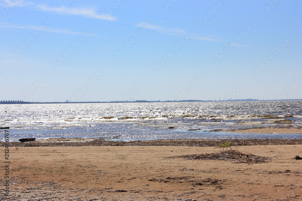 Coastline of Sandy Sea Shore Dirty Beach with Garbage and Waste on Sandy Beach in Summer Time. Nature of Sea Shore Damaged by People and Industrial Waste. Pollution and Ecology Problems Concept. 