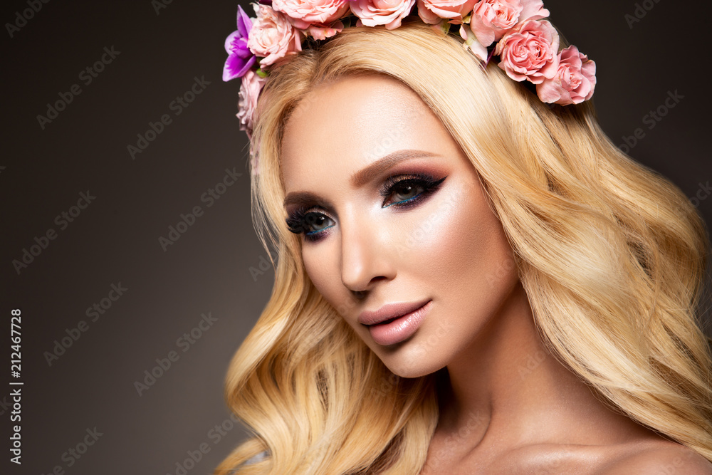 Beautiful Woman with Long Curly Hair, Perfect Makeup and Wreath of Spring Flowers