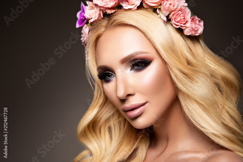 Beautiful Woman with Long Curly Hair  Perfect Makeup and Wreath of Spring Flowers