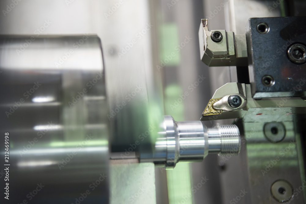 The CNC lathe or turning machine cutting the thread at end of aluminum shaft part.Hi-technology manufacturing process. The CNC lathe or turning machine cutting the thread at end of aluminum shaft part.Hi-technology manufacturing process.