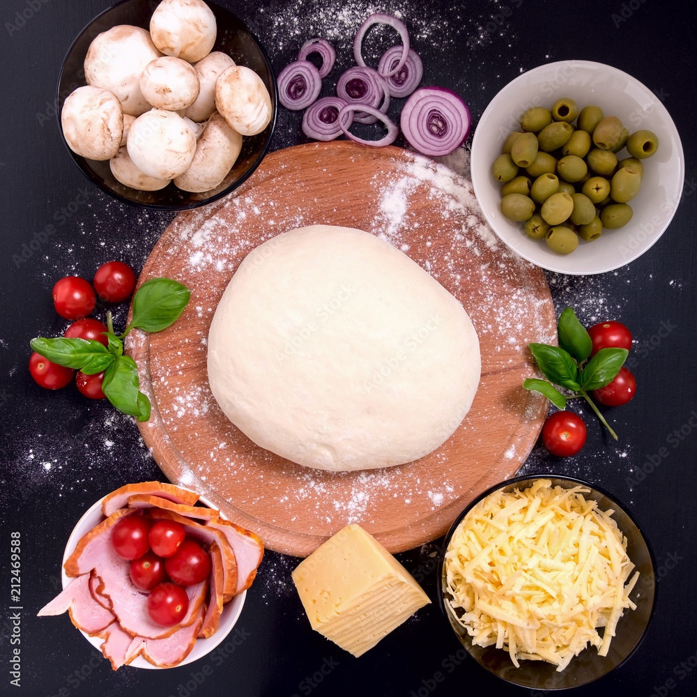 Pizza with meat Vegetables and Spices on a black background. Top view. Pizza with meat Vegetables and Spices on a black background. Top view.