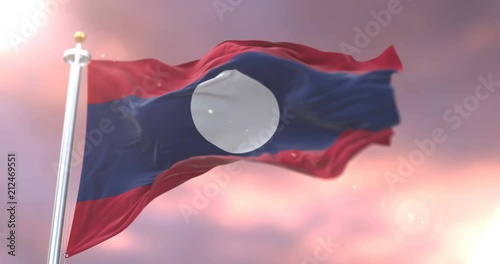 Flag of Laos waving at wind at sunset in slow, loop photo