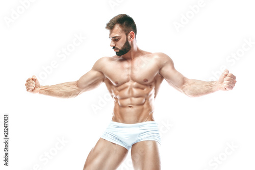 bodybuilder posing. Beautiful sporty guy male power. Fitness muscled manin white lingerie. on isolated white background.