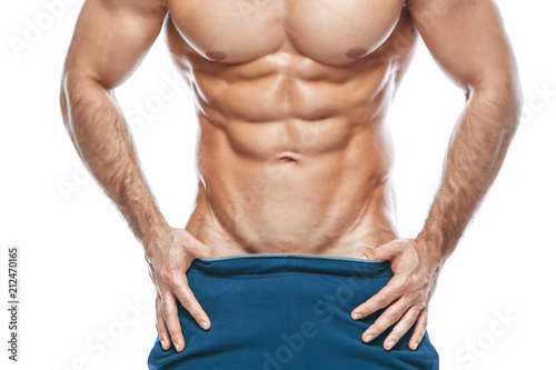 bodybuilder posing. Beautiful sporty guy male power. Fitness muscled in blue shorts. on isolated white background. Man with muscular torso. Strong Athletic Man Fitness Model Torso showing six pack abs
