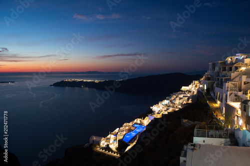 Whitewashed Houses with View onto Sea and Oia during Sunset in Imerovigli, Santorini, Greece