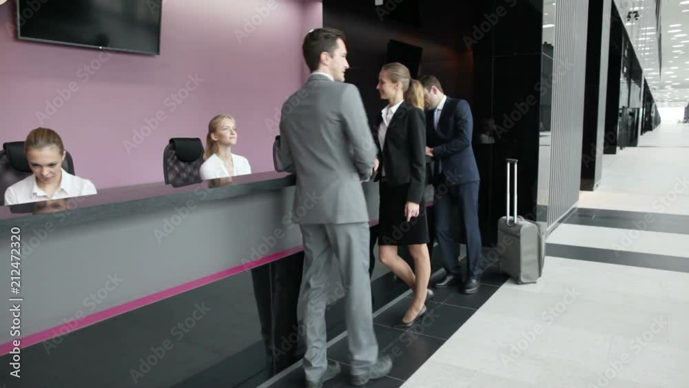 Business people filling forms at reception front desk