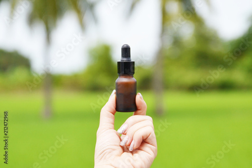woman hand holding essential oil