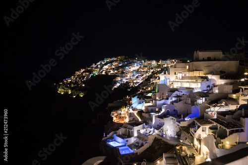Whitewashed Houses on Cliffs with Sea View at Night in Imerovigli  Santorini  Greece