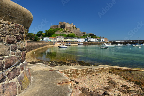 Mont Orguiel Castle,Gorey, Jersey, U.K. July 7th 2018. The 12th century medieval monument and harbor with a rising tide in the Summer, once residence to Sir Walter Raleigh in 1600. photo