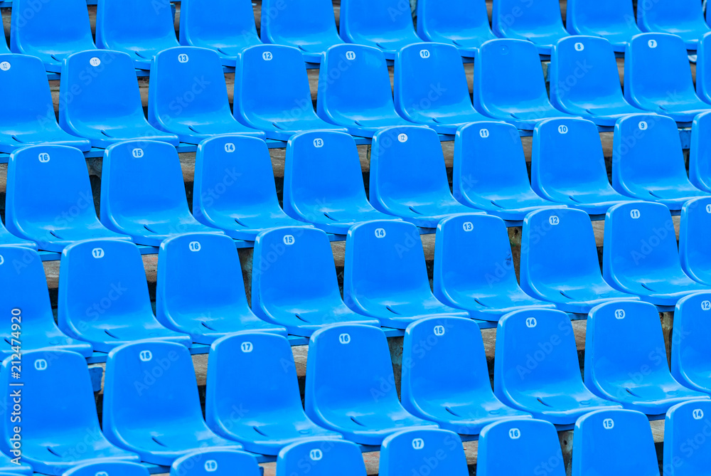 Empty blue plastic seats in the audience. Empty blue plastic seats in the audience.