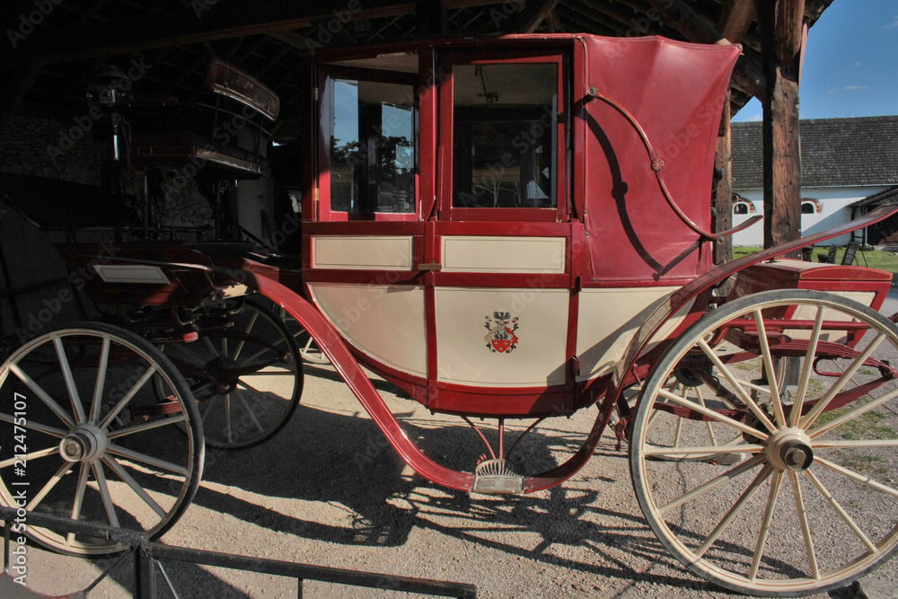 A red coach standing in a coach house