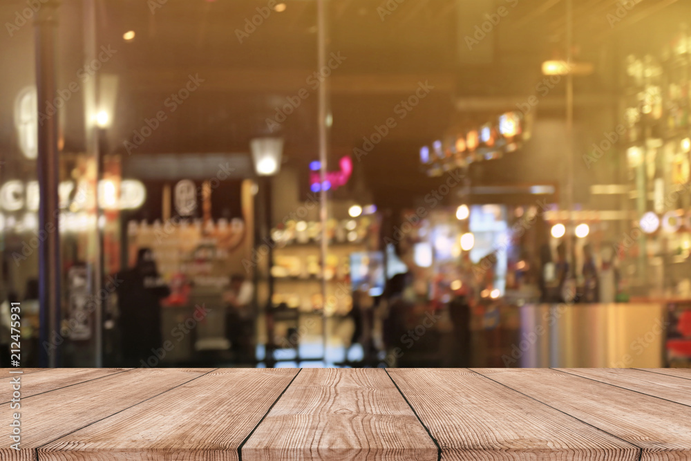 Empty wood table top with blurred light bokeh in night cafe restaurant background