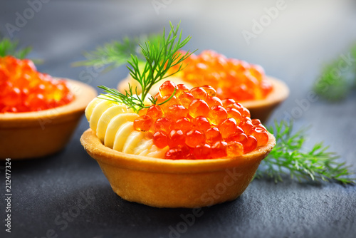 Salmon caviar. Tartlets with red caviar closeup. Gourmet food. Seafood. Trout caviar