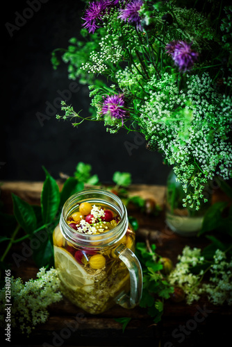 Gooseberry and eldeflower  vodka..style vintage. selective focus photo