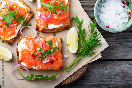 Принти на полотні Smoked salmon sandwich with cream cheese on wooden table