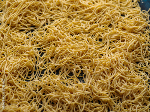 Dried egg noodles. Raw Fresh Spaghetti. Food background