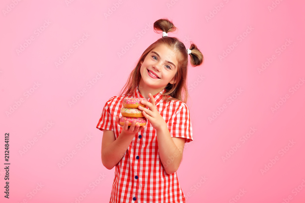 Girl with donuts on a pink background. Girl with donuts on a pink background.