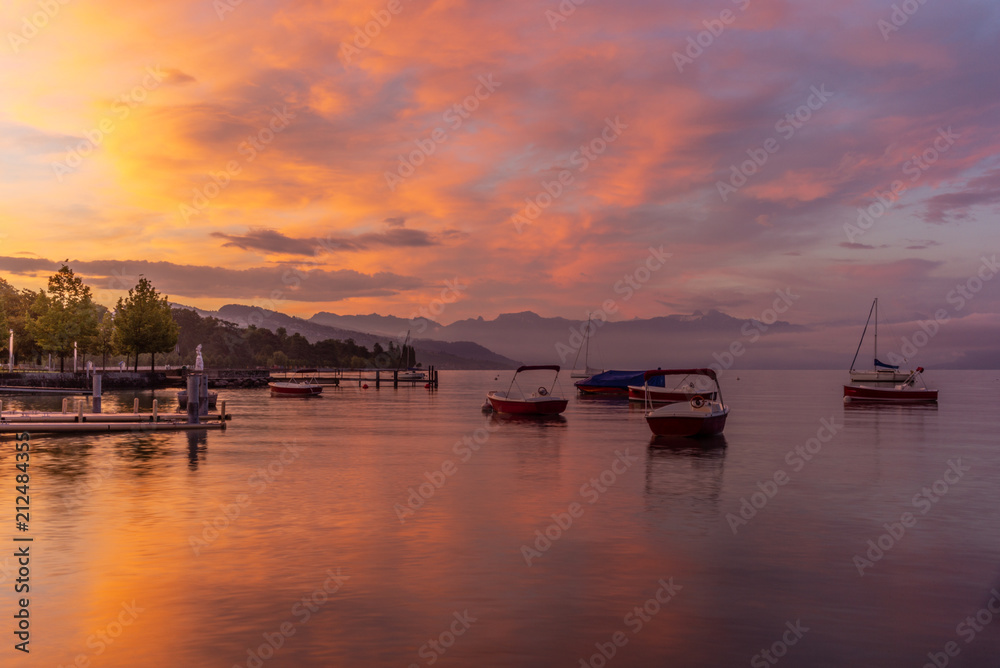 Colorful sunrise on the marina of Lausanne on the Lake Leman in summer with the view of the Swiss Alps in background - 1
