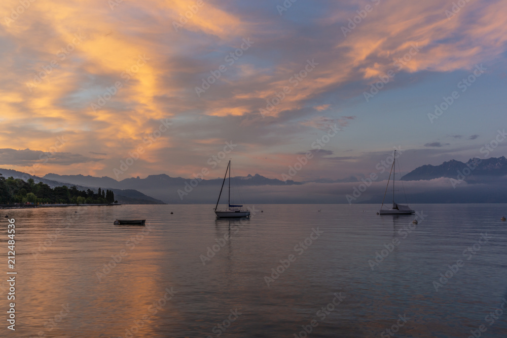 Colorful sunrise on the marina of Lausanne on the Lake Leman in summer with the view of the Swiss Alps in background - 11