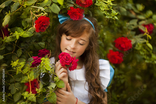 Girl in fairy tale park with tree in spring photo